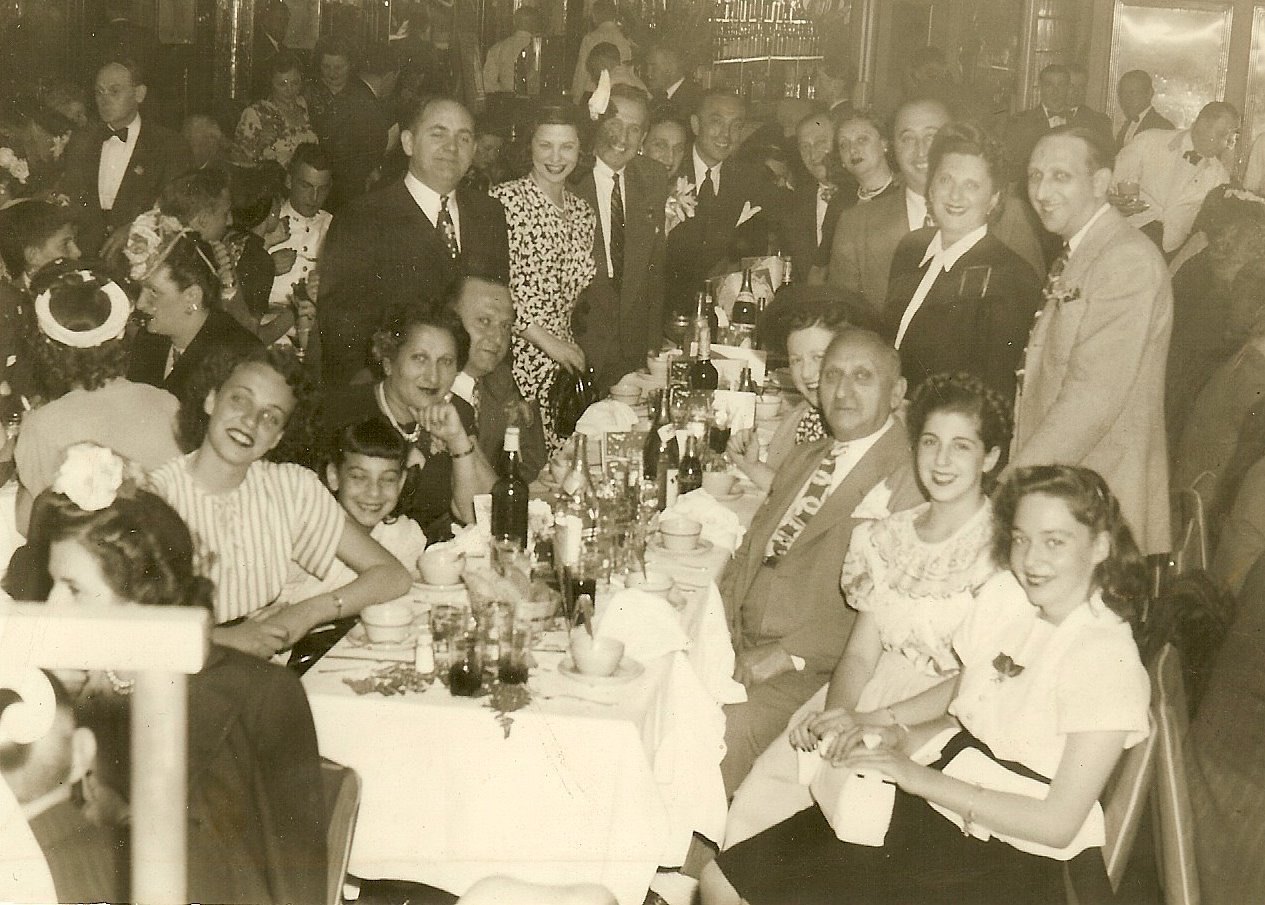 Sepia photograph of a large family gathered around a banquet table
